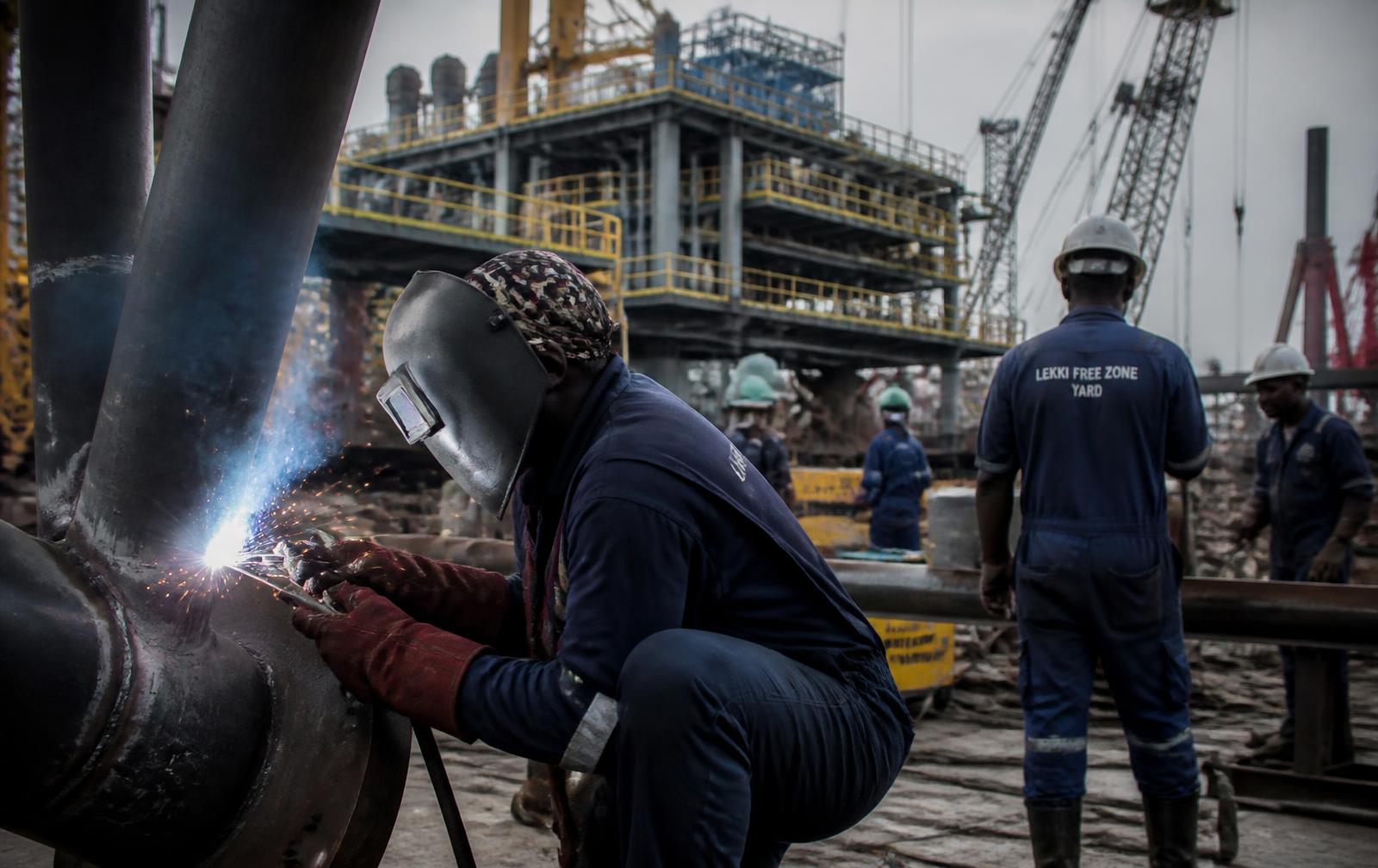 Nigerian technicians working at an offshore fabrication yard